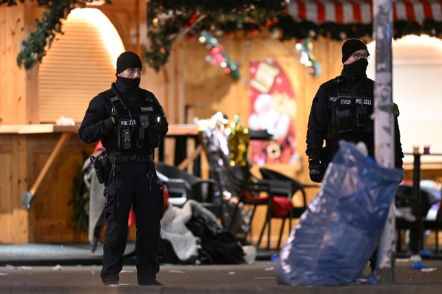 Polisi berdiri di pasar Natal di Magdeburg, Jerman, Sabtu dini hari, 21 Desember 2024, setelah seorang pengemudi menabrak sekelompok orang di pasar pada Jumat malam. (Hendrik Schmidt/dpa melalui AP)