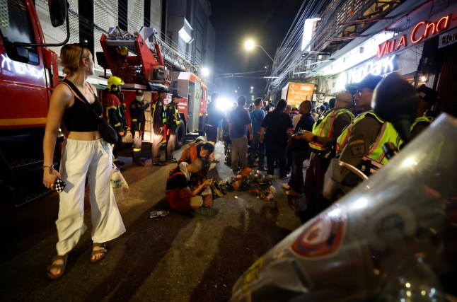epa11797912 Seorang turis asing (kiri) melihat lokasi kejadian pasca kebakaran di Hotel Ember di Bangkok, Thailand, 29 Desember 2024. Menurut polisi di lokasi kejadian, sejumlah korban dilaporkan ketika terjadi kebakaran di hotel dekat lokasi tersebut. tempat wisata Jalan Khao San.